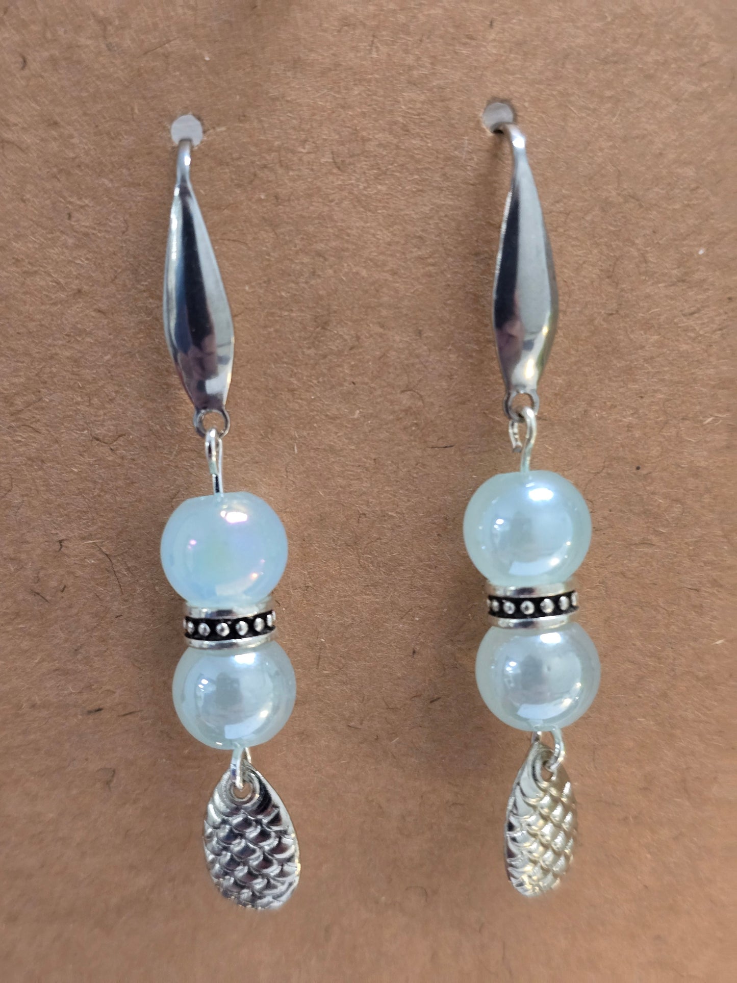 Light blue dangle earrings with spinners spoon